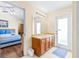 Bright bathroom featuring wood vanity, large mirror, exterior door, and bedroom access at 263 Reserve Dr, Davenport, FL 33896