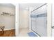 Clean bathroom featuring shower, linoleum floors and a view to the walk-in closet with washer and dryer at 263 Reserve Dr, Davenport, FL 33896