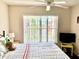 Bright bedroom with a large window, fan, and plush toy accents at 263 Reserve Dr, Davenport, FL 33896