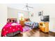 bedroom featuring wood floors, light walls, twin beds with colorful decor and themed accessories at 263 Reserve Dr, Davenport, FL 33896