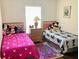 The kid-friendly bedroom is furnished with twin beds, playful decor, and bright accents at 263 Reserve Dr, Davenport, FL 33896
