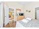 Bedroom featuring wood floors, neutral walls, a TV, and a view to the kitchen/dining room at 263 Reserve Dr, Davenport, FL 33896