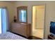 Bright bedroom featuring a dresser, a door and sliding glass doors offering outdoor access at 263 Reserve Dr, Davenport, FL 33896
