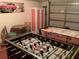 Finished garage with foosball and air hockey tables for entertainment at 263 Reserve Dr, Davenport, FL 33896