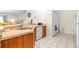 Bright kitchen featuring tan counters, wood cabinets, white appliances, and a stainless steel sink at 263 Reserve Dr, Davenport, FL 33896