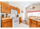 Well-equipped kitchen featuring white appliances, tan countertops, and wooden cabinets at 263 Reserve Dr, Davenport, FL 33896