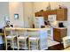 Cozy kitchen with breakfast bar seating and ample cabinet storage space at 263 Reserve Dr, Davenport, FL 33896