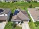 Aerial view of home showing solar panels, manicured lawn, and neighboring properties in a residential area at 278 Alford Dr, Davenport, FL 33896