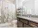 Cozy bathroom featuring granite countertops, a vanity, and a shower with a floral curtain at 278 Alford Dr, Davenport, FL 33896