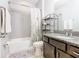 Well-lit bathroom featuring granite countertops, a vanity, and a shower with a floral curtain at 278 Alford Dr, Davenport, FL 33896