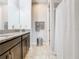 Bright bathroom featuring a granite vanity, a large mirror, and shower with curtain at 278 Alford Dr, Davenport, FL 33896