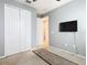Neutral bedroom featuring a closet, rug, and wall-mounted TV with grey walls at 278 Alford Dr, Davenport, FL 33896