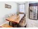 Dining area with a large wooden table, decorative chairs, stainless steel refrigerator, and window at 278 Alford Dr, Davenport, FL 33896