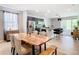 Open concept: Dining area adjacent to a modern kitchen with an island and bar stool seating at 278 Alford Dr, Davenport, FL 33896