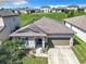 Attractive home features solar panels, a tidy front yard, and a two-car garage in a suburban setting at 278 Alford Dr, Davenport, FL 33896
