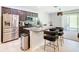 Modern kitchen features stainless steel appliances, granite countertops, and stylish bar stool seating at 278 Alford Dr, Davenport, FL 33896
