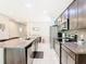 Open kitchen features stainless steel appliances, granite countertops, and easy access to the dining area at 278 Alford Dr, Davenport, FL 33896