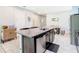 Modern kitchen island features dark cabinets, stainless steel dishwasher, and granite countertop with sink at 278 Alford Dr, Davenport, FL 33896