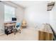 Bright office space with a large window, desk, chair, and wooden shelving at 278 Alford Dr, Davenport, FL 33896