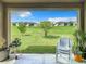 View of the backyard from the covered patio with grill, seating and beautiful green space at 278 Alford Dr, Davenport, FL 33896