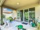 Inviting covered patio with outdoor seating and a glimpse of the well-maintained lawn at 278 Alford Dr, Davenport, FL 33896