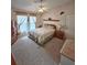 Cozy bedroom with plush carpet, ceiling fan, and a comfortable bed with decorative pillows at 2909 Pine Tree Dr, Edgewater, FL 32141
