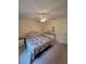 Bright bedroom with neutral carpet, a ceiling fan, and a comfortable bed with colorful bedding at 2909 Pine Tree Dr, Edgewater, FL 32141