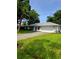 Charming single-story home with a well-manicured lawn, a two-car garage, and mature landscaping at 2909 Pine Tree Dr, Edgewater, FL 32141