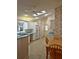 Bright kitchen with skylight, white cabinets, neutral countertops, and eat in breakfast nook at 2909 Pine Tree Dr, Edgewater, FL 32141