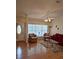 Inviting living room featuring hardwood floors, neutral walls, vaulted ceiling, and a decorative ceiling fan at 2909 Pine Tree Dr, Edgewater, FL 32141