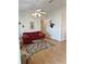 Inviting living room featuring hardwood floors, neutral walls, vaulted ceiling, and a decorative ceiling fan at 2909 Pine Tree Dr, Edgewater, FL 32141