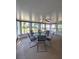 Inviting sunroom with a glass-top table and seating, perfect for enjoying views of the surrounding landscape at 2909 Pine Tree Dr, Edgewater, FL 32141