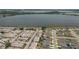 Aerial view of residential neighborhood near a lake. The home for sale is marked with an arrow at 299 Winter Ridge Blvd # 299, Winter Haven, FL 33881