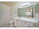 Well-lit bathroom featuring a shower, a toilet, and a vanity with ample counter space at 299 Winter Ridge Blvd # 299, Winter Haven, FL 33881