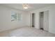 Serene bedroom with tile flooring, natural light, and dual closets for ample storage at 299 Winter Ridge Blvd # 299, Winter Haven, FL 33881