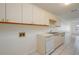 A kitchen featuring white cabinets and white appliances including a dishwasher and a sink at 299 Winter Ridge Blvd # 299, Winter Haven, FL 33881