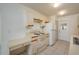 Efficient kitchen featuring white cabinetry, tile floor, and essential appliances at 299 Winter Ridge Blvd # 299, Winter Haven, FL 33881