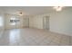 Bright, tiled living room with neutral walls, ceiling fan, and natural light from the front window at 299 Winter Ridge Blvd # 299, Winter Haven, FL 33881