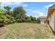 Spacious backyard features a wooden fence, lush greenery, and patio at 320 Boger S Blvd, Lakeland, FL 33803