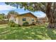 The house features a large backyard with lush landscaping, providing privacy and a serene outdoor space at 320 Boger S Blvd, Lakeland, FL 33803