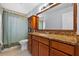 Traditional bathroom with a wood vanity, granite countertop, and a decorative cabinet at 320 Boger S Blvd, Lakeland, FL 33803