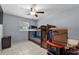 Bedroom with a bunk bed, ceiling fan, window, and tile flooring at 320 Boger S Blvd, Lakeland, FL 33803