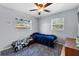 Bright bedroom featuring a ceiling fan, windows, a bed, and a patterned rug at 320 Boger S Blvd, Lakeland, FL 33803