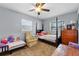Bedroom with a ceiling fan, two beds and ample natural light at 320 Boger S Blvd, Lakeland, FL 33803