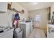 Laundry room with washer, dryer, utility sink, and door to the exterior at 320 Boger S Blvd, Lakeland, FL 33803