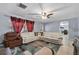 Bright living room boasts a large cream sectional sofa, ceiling fan, and unique accent rug at 320 Boger S Blvd, Lakeland, FL 33803