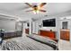 Main bedroom features a ceiling fan, a large bed and an ensuite bathroom at 320 Boger S Blvd, Lakeland, FL 33803