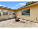 Back patio with seating area, featuring a fire pit and shade at 320 Boger S Blvd, Lakeland, FL 33803