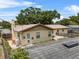 Rear view of home featuring a chimney, fenced yard and patio, perfect for outdoor gatherings at 320 Boger S Blvd, Lakeland, FL 33803