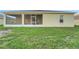 Exterior of the home showing the enclosed patio and lawn at 327 Cloverdale Rd, Winter Haven, FL 33884